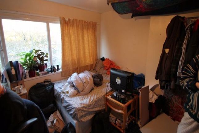 Cozy Single Bedroom Featuring A Large Window With ...