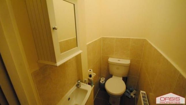 A Clean And Functional Bathroom Featuring A Toilet...