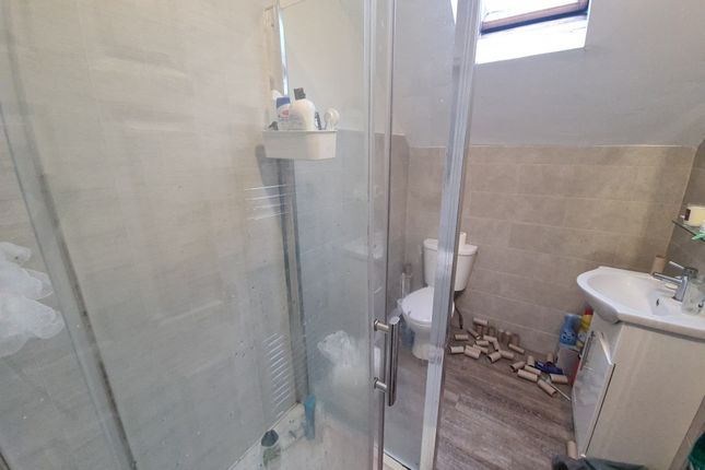 A Modern Bathroom Featuring A Glass-Enclosed Showe...