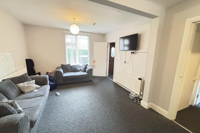 A Spacious And Well-Lit Living Room Featuring Comf...