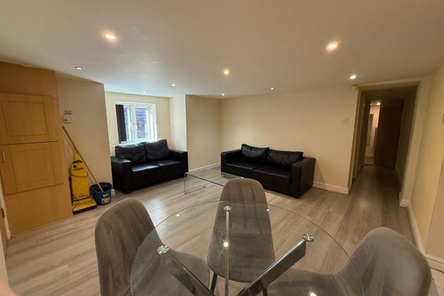A Modern Living Room Featuring Sleek Black Sofas A...