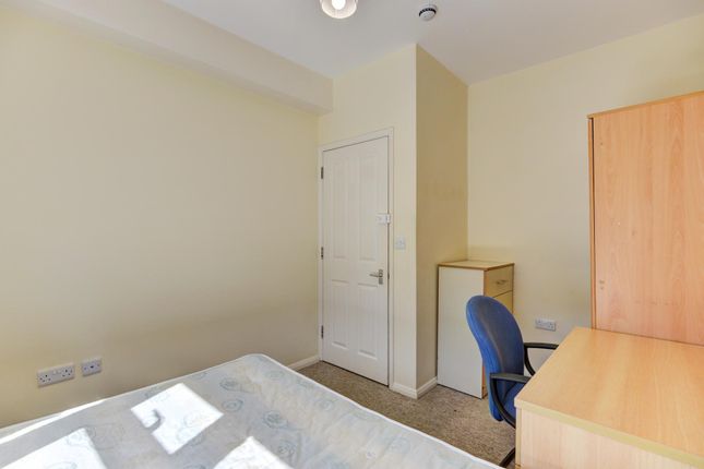 A Well-Lit Double Bedroom Featuring A Bed, Wardrob...