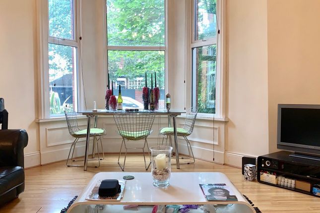 A Bright And Inviting Living Room Featuring A Larg...