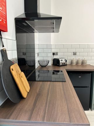 Bright And Modern Kitchen Area Featuring Sleek Cou...