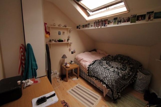 Cozy Single Bedroom Featuring A Skylight That Allo...