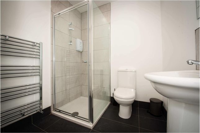 A Modern, Clean Bathroom With A Spacious Shower En...