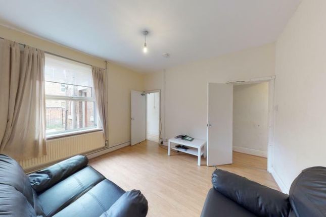 Bright And Inviting Living Room With Ample Natural...