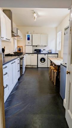 A Spacious And Bright Kitchen Featuring Modern App...
