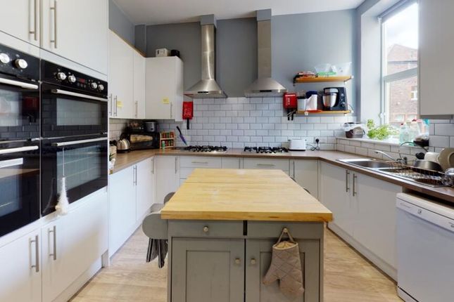 A Modern Kitchen Featuring Ample Counter Space, Sl...