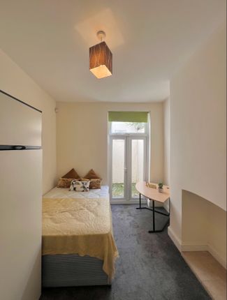 A Bright And Inviting Double Bedroom Featuring Lar...