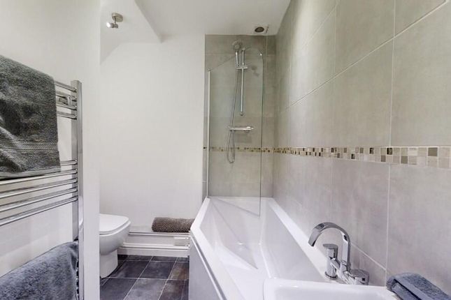 A Modern Bathroom Suite Featuring A Spacious Batht...