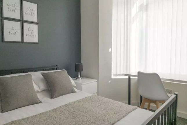 Bright And Stylish Master Bedroom Featuring A Comf...