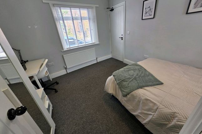 A Neat And Tidy Single Bedroom Featuring A Comfort...