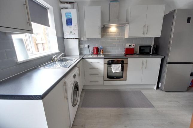 A Bright And Modern Kitchenette Equipped With Esse...