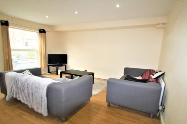 A Cozy Living Room Featuring Two Grey Sofas Arrang...