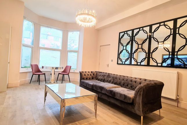 Spacious, Well-Lit Living Room With A Large Bay Wi...