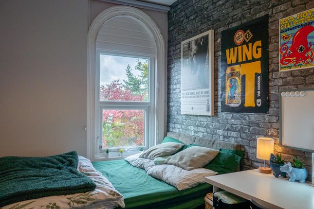 A Cozy Bedroom Featuring A Large Window That Provi...