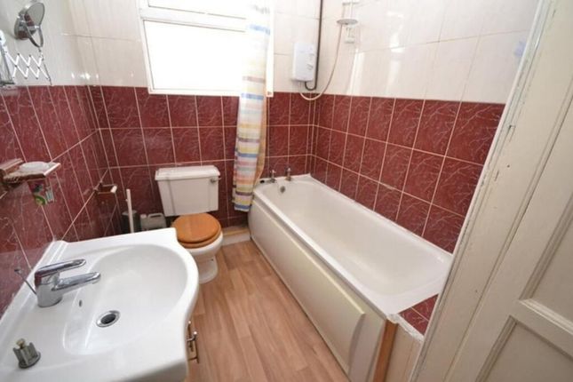 A Well-Maintained Bathroom Featuring A Bathtub And...