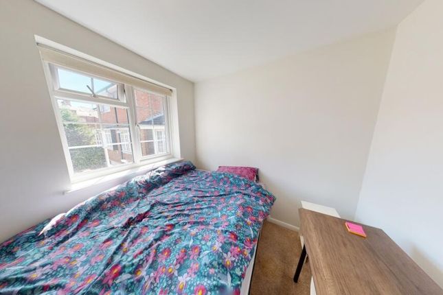A Bright And Clean Single Bedroom Featuring A Larg...