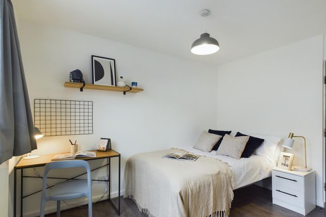 A Bright And Inviting Double Bedroom Featuring A c...