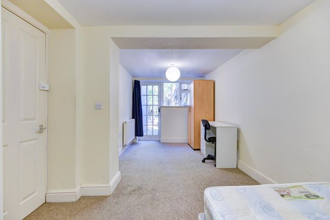 A Bright And Welcoming Living Room Featuring Ample...