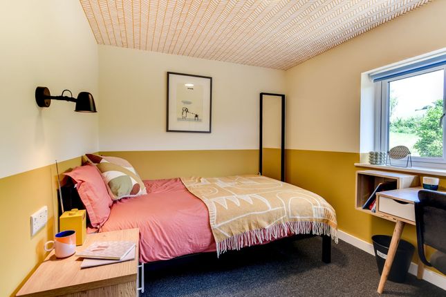 A Cozy Single Bedroom Featuring A Comfortable Bed ...