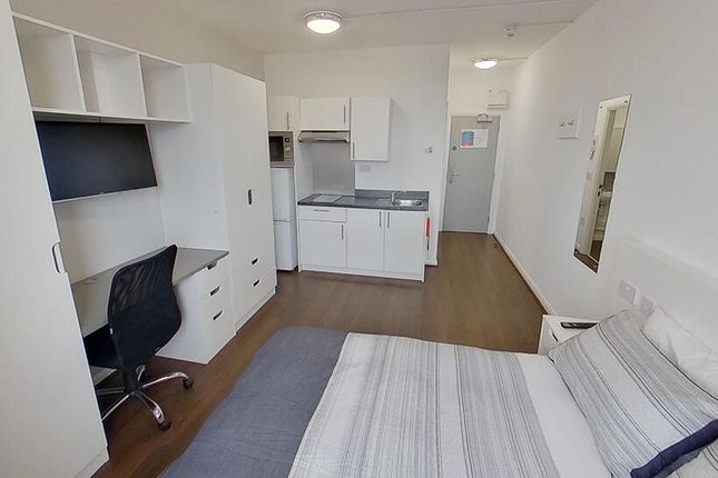 A Bright And Tidy Master Bedroom Featuring A Comfo...