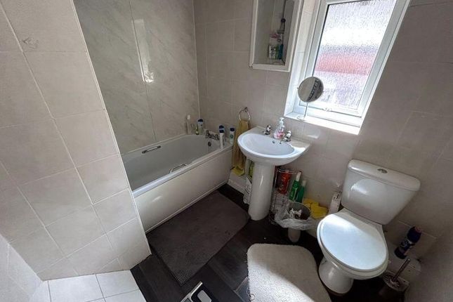 A Neat And Functional Bathroom Featuring A White B...