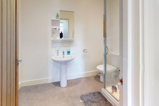 This Well-Maintained Bathroom Features A Modern Sh...