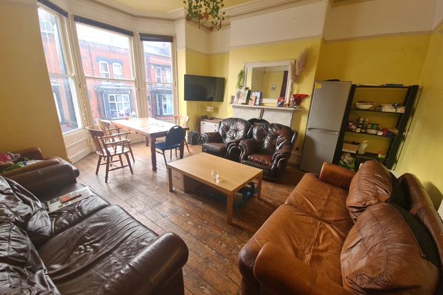 A Spacious And Inviting Living Room Featuring Mult...