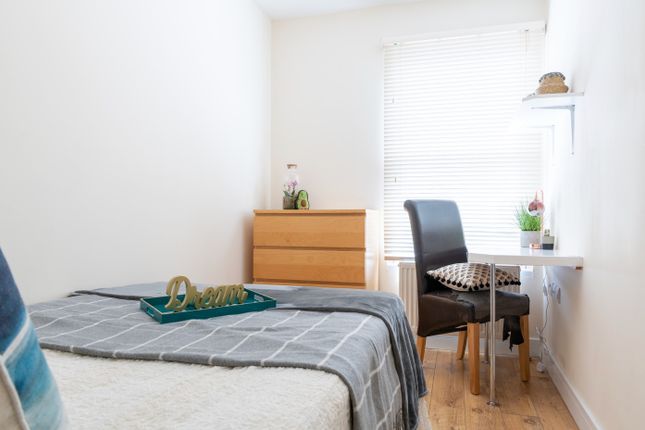 A Cozy Double Bedroom Featuring A Comfortable Bed,...