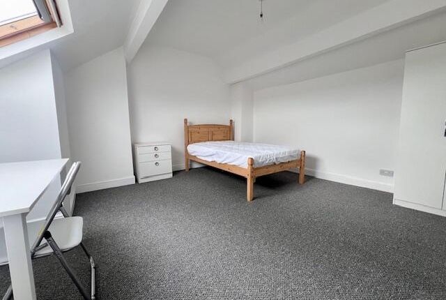 A Spacious And Bright Master Bedroom Featuring A W...