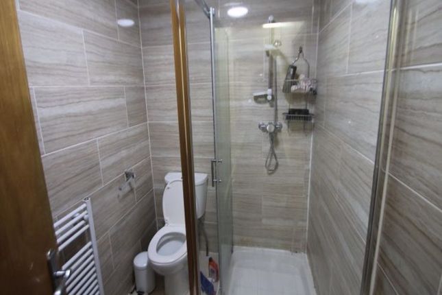 A Modern Bathroom Featuring A Glass-Enclosed Showe...