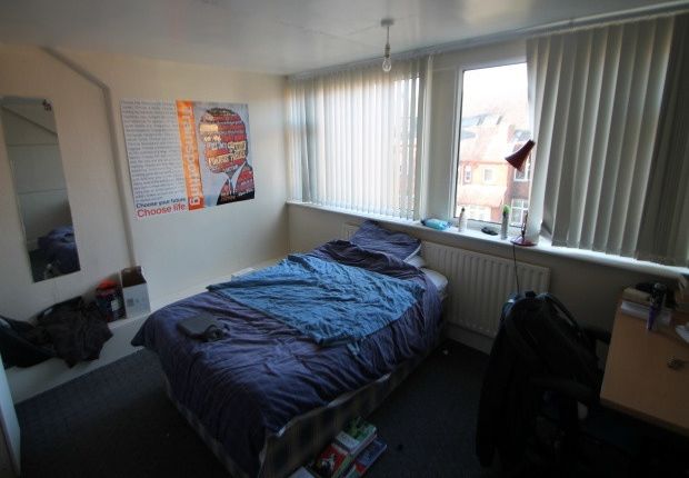 A Cozy Bedroom Featuring A Neatly Made Bed Near A ...