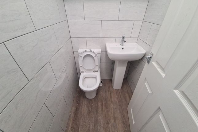 Bright And Clean Small Toilet Room Featuring Moder...
