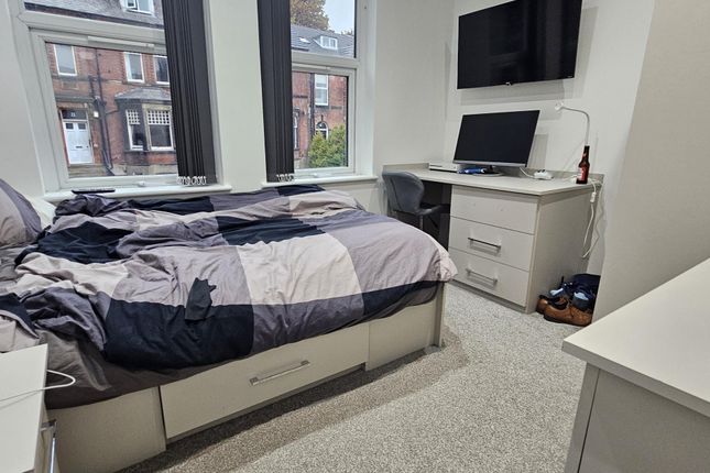 A Well-Lit, Tidy Bedroom Featuring A Double Bed, A...