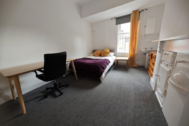 A Bright And Tidy Master Bedroom Featuring A Comfo...