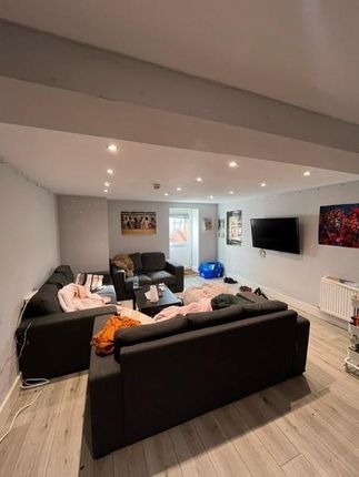 A Spacious And Modern Living Room Featuring Contem...