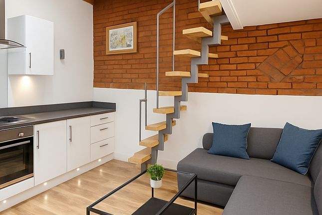 A Modern Living Room Featuring A Sleek Kitchen Are...