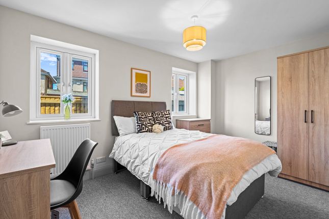 Bright And Inviting Double Bedroom Featuring A Com...