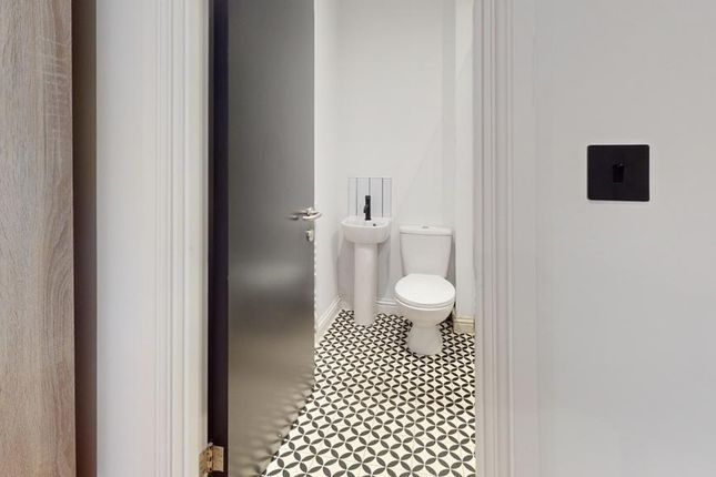 A Stylish And Clean Single Toilet With Modern Tili...
