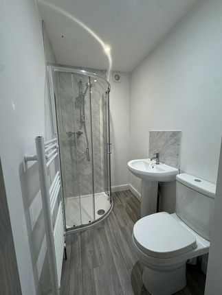 A Modern Bathroom Featuring A Curved Glass Shower ...