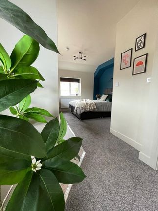 A Bright And Inviting Master Bedroom Featuring A c...