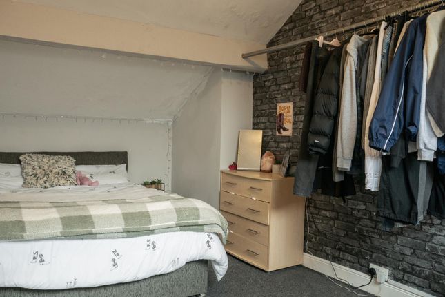 A Cozy Bedroom Featuring A Comfortable Double Bed ...