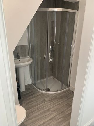 Modern Bathroom Featuring A Corner Shower Enclosur...