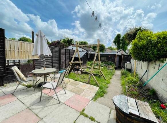 A Bright And Inviting Garden Space Featuring A Pav...