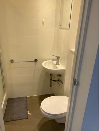A Tidy Bathroom Featuring Essential Amenities, Off...