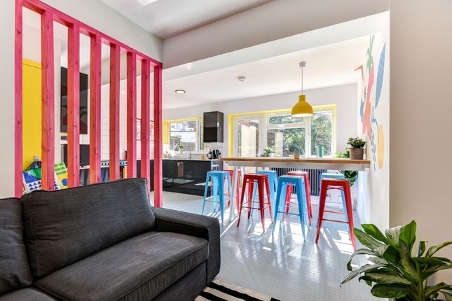 Bright And Vibrant Living Room Featuring A Comfort...