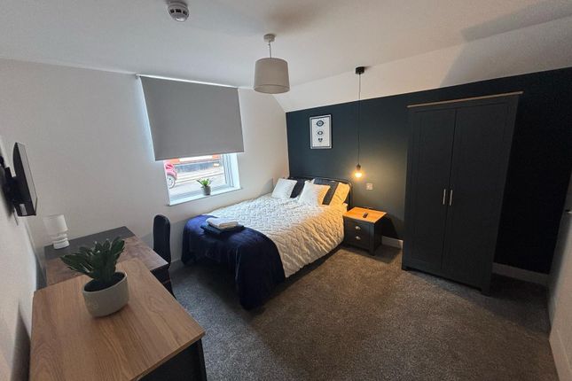 A Cozy Double Bedroom Featuring A Stylish Bed And ...