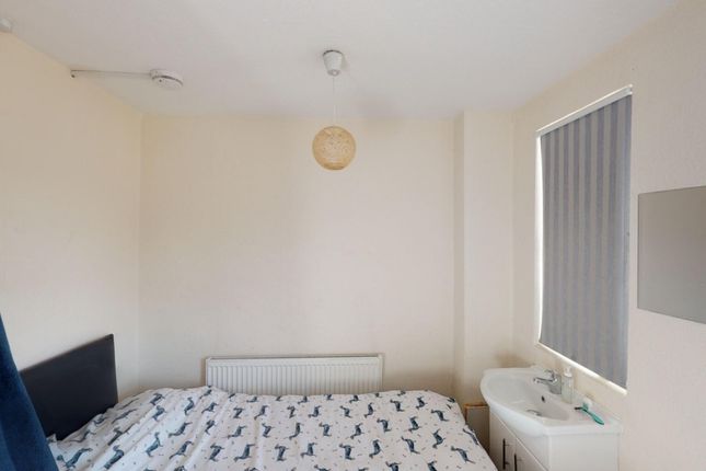 A Neat And Simple Single Bedroom With A Bed, Radia...